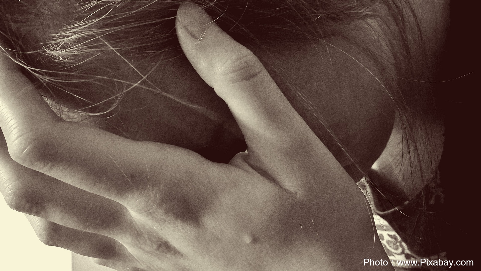 Woman crying hands over face