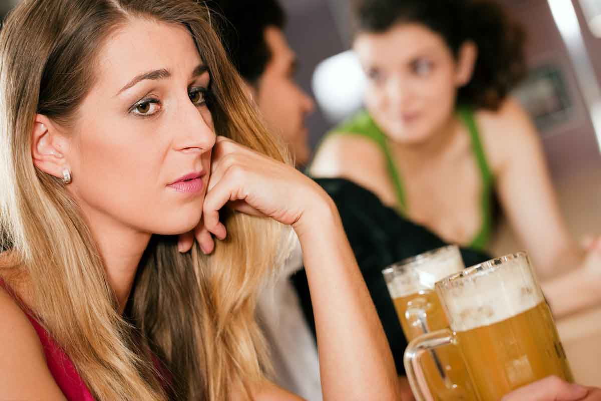 A Woman feels lonely and isolated even though she is surrounded by the crowd.