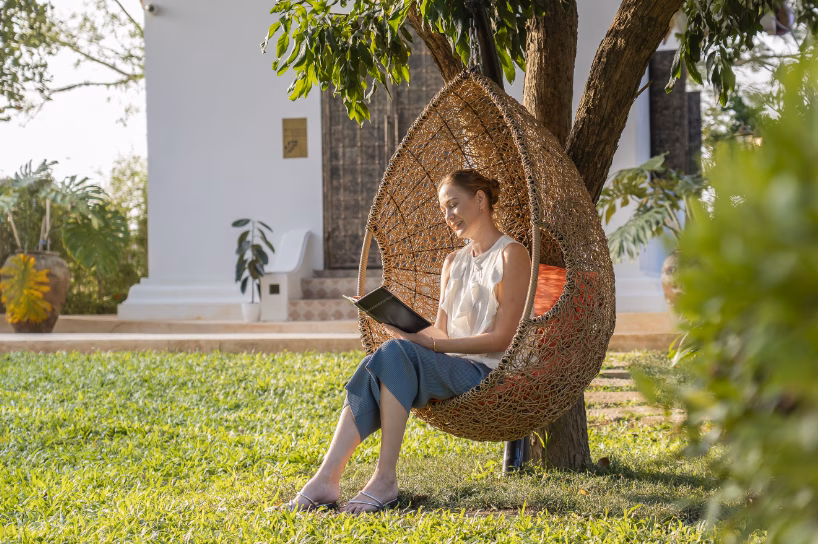 female client on wicker hanging chair