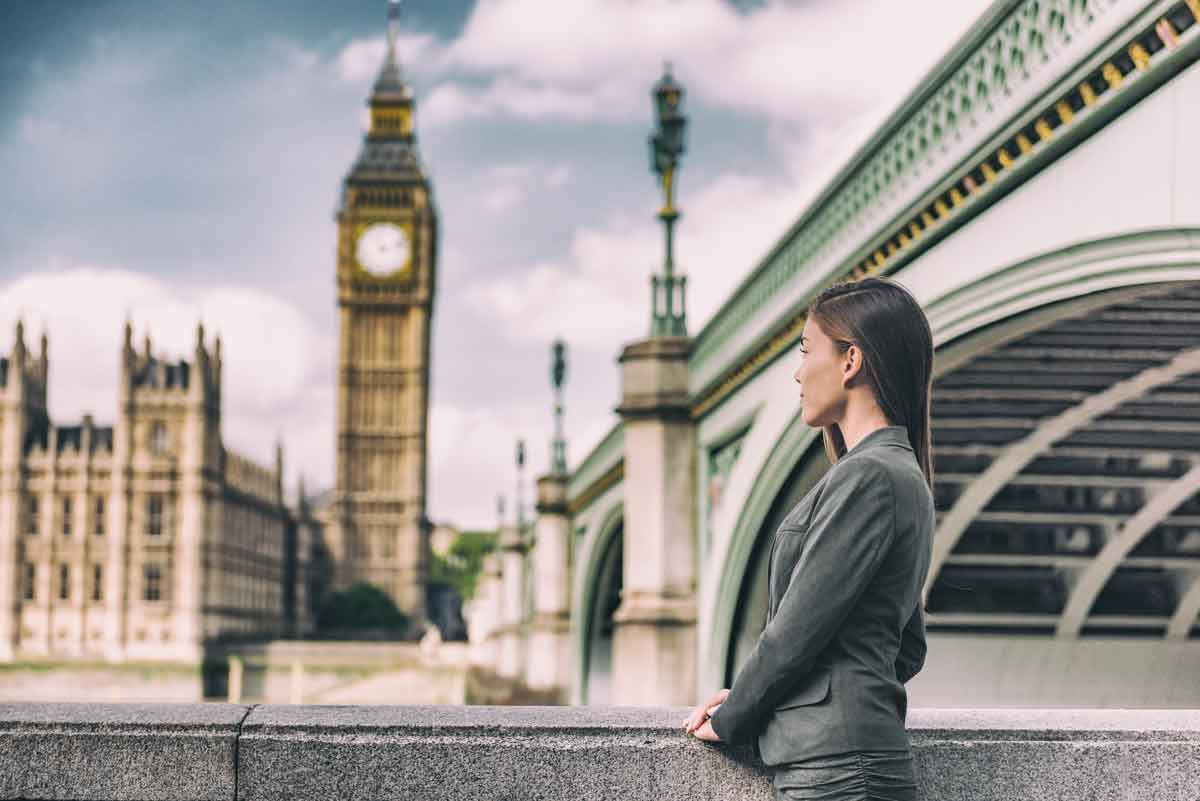 woman standing on the bridge with the big ben background