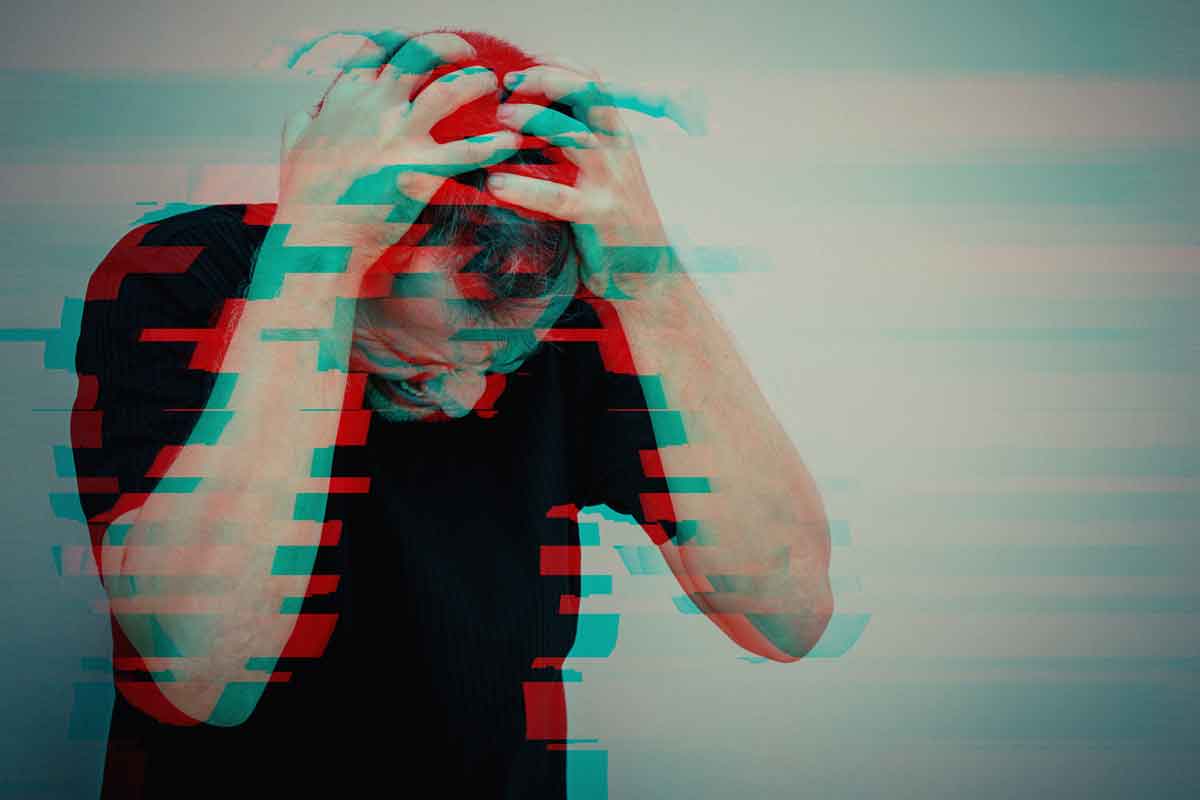 one sad man standing near a wall and covers his face