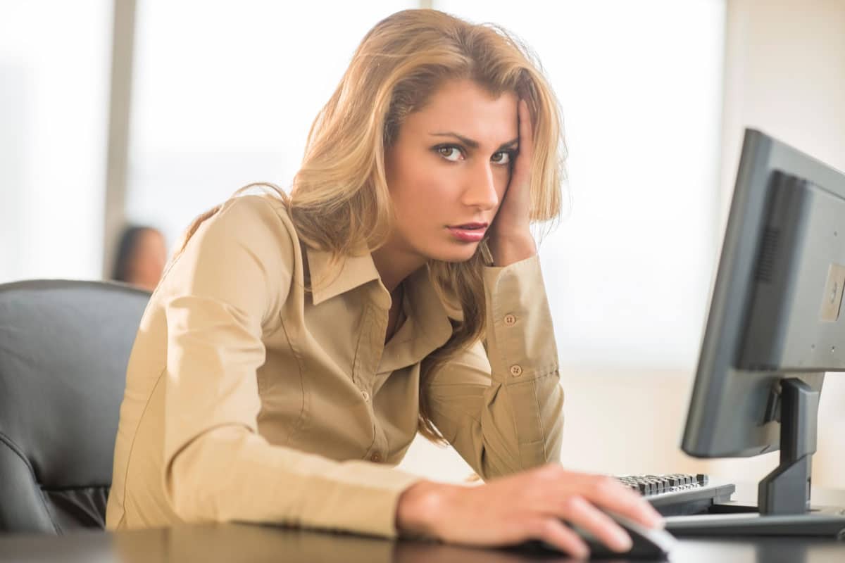 an office woman is feeling irritated with her unnecessary workload.